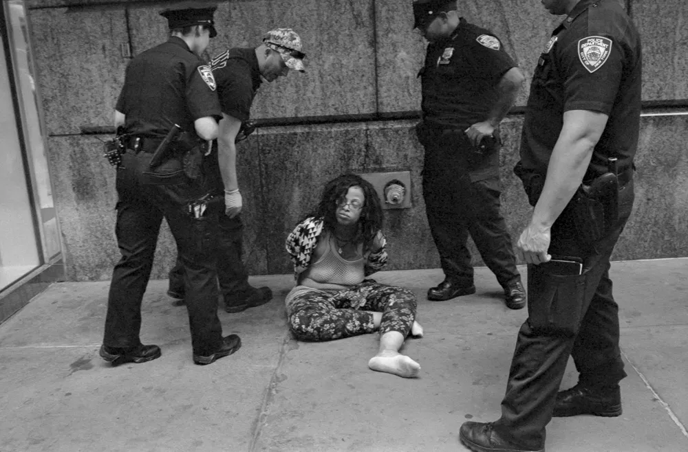 Photo of woman being arrested by 4 cops